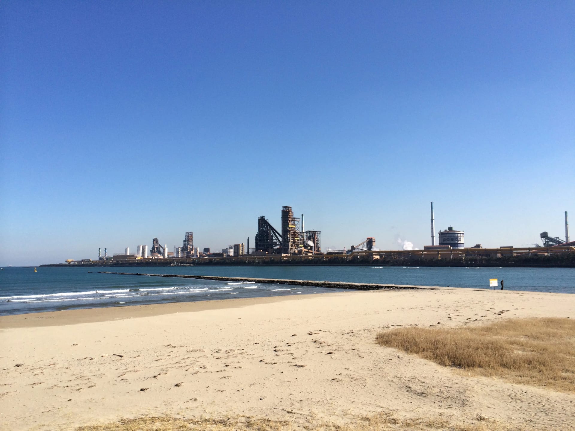 View of POSCO's steel mill in Pohang, South Korea, its chimneys stretching along the coast, seen from Songdo beach
